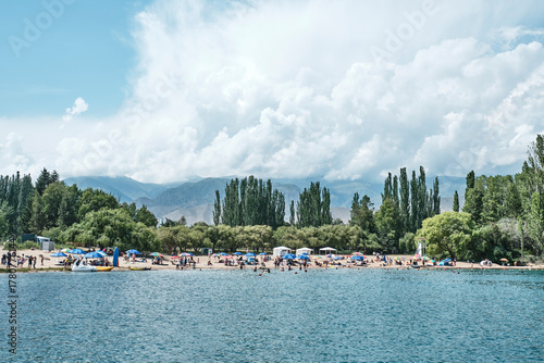 Issyk-Kul lake beach near Cholpon-Ata, scenic mountains and summer vacation, Kyrgyzstan