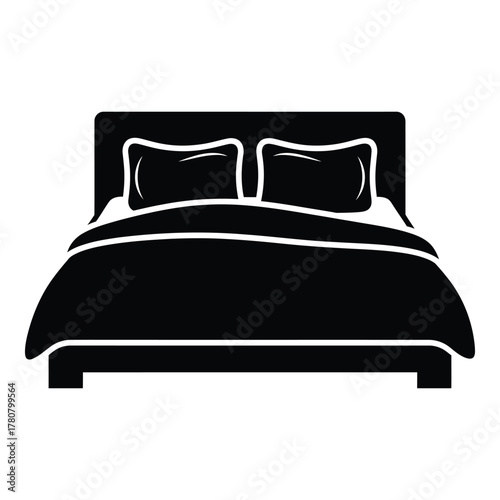 Comfortable bed with pillows and blanket inviting relaxation and rest