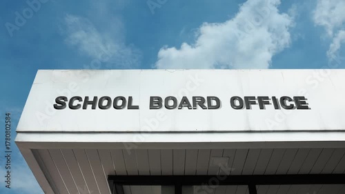 School Board Office word sign displayed on a governmental or educational building under a clear blue sky, symbolizing educational policy, administration, public schooling, governance, civic oversight