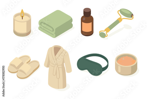 Spa essentials with towel, bottle, roller, candle, robe, eye mask, bowl, slippers