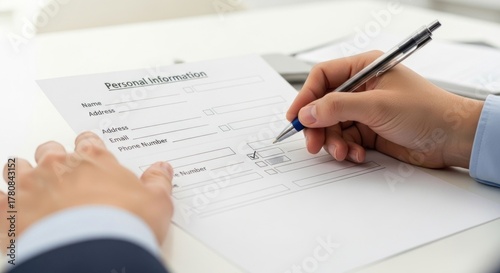 A person filling out a personal information form.