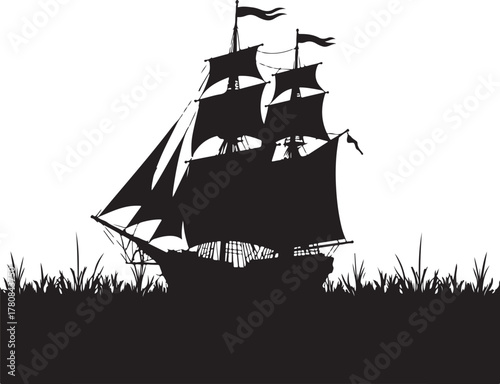 Black silhouette of a tall ship with sails and flags