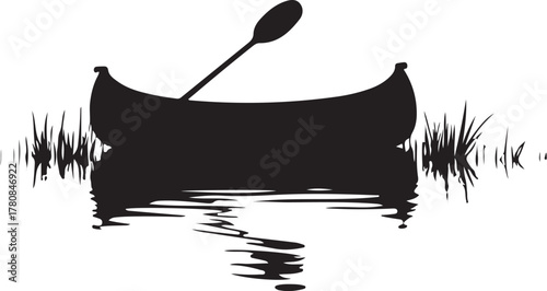 Black silhouette of canoe with paddle and grass reflection