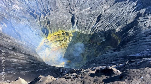 The crater of the volcano on Mount Bromo, and sulfur fumes rise in the air in East Java. The volcano is located inside the Tengger Caldera. An active volcano in Indonesia. 4К