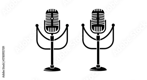 Two vintage style microphones stand isolated on a plain white background