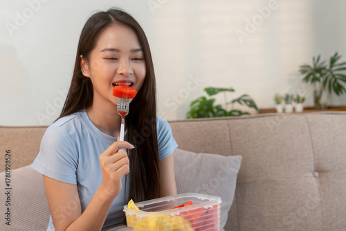 Woman enjoying fresh fruit at home