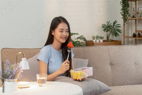 Woman enjoying fresh fruit at home