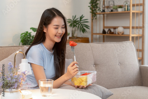 Woman enjoying fresh fruit at home