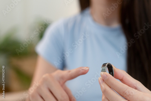 Woman showing health-monitoring smart ring at home
