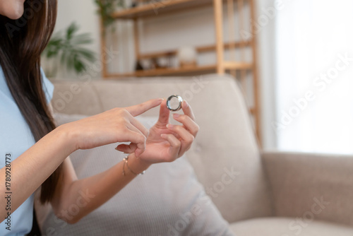 Woman showing health-monitoring smart ring at home