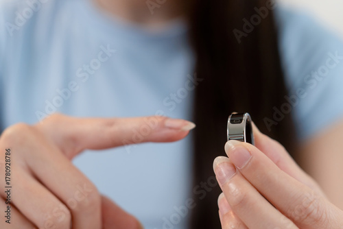 Woman showing health-monitoring smart ring at home