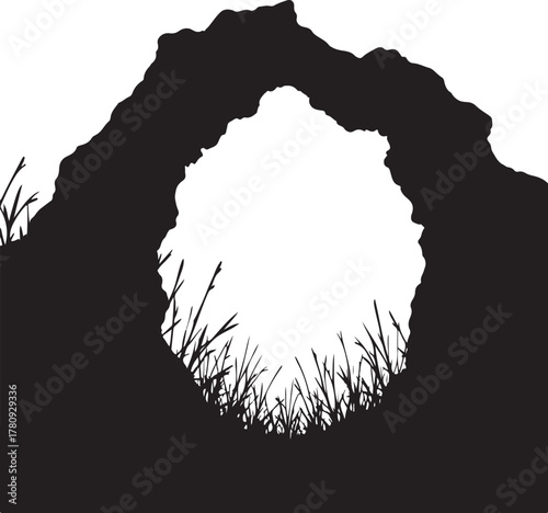 Black silhouette of a natural archway with grass rock formation