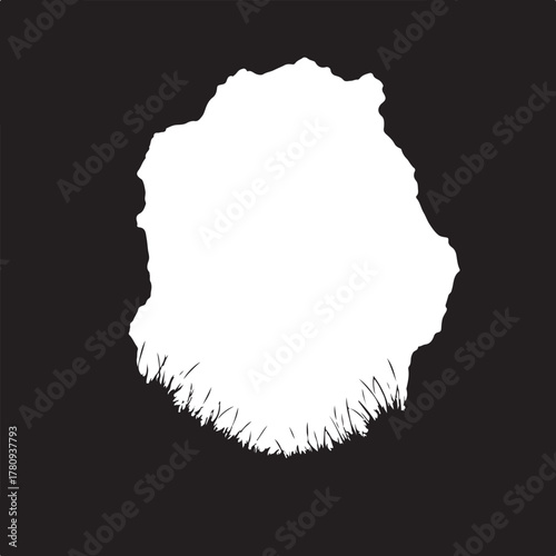 Black silhouette of rock formation with grass stone