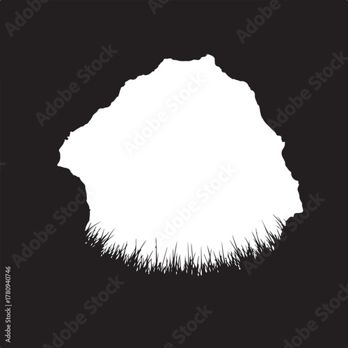 White rock formation silhouette with grass foreground