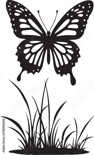 Black butterfly silhouette above grass blades insect
