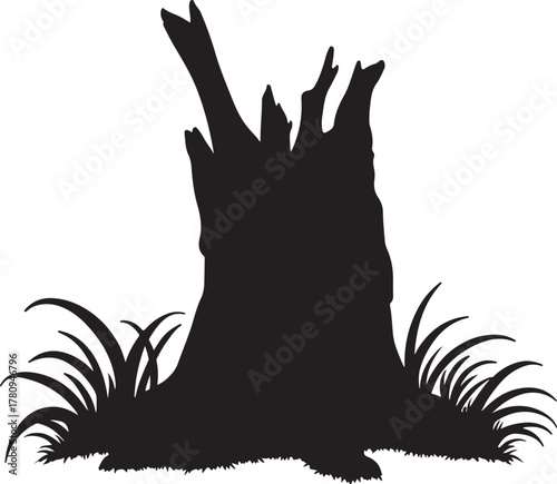 Black silhouette of a jagged tree stump with grass