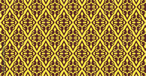 Brown and yellow diamond-shaped geometric pattern with intricate symmetrical motifs forming a repeating ornamental structure.