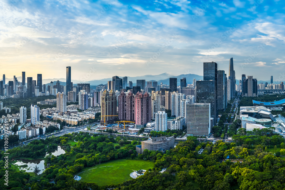 Obraz premium Aerial view of the downtown financial district skyline with modern office buildings and lush green space in Shenzhen.