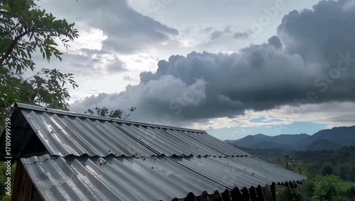 Dramatic Cloudscape Above a Corrugated Iron Roof, Framing a Serene Mountain Valley