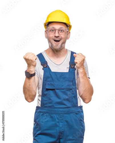 Excited construction worker yelling with opened mouth and clenched fists, isolated on white background. Surprised repairman celebrates success. Craftsman against white wall