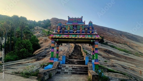 Colorful kasi viswanathar temple entrance and stone steps leading up Thiruparankundram Hill in Madurai, Tamil Nadu, showcasing the natural rock landscape and peaceful spiritual atmosphere