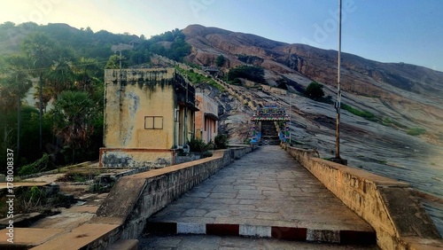 Colorful kasi viswanathar temple entrance and stone steps leading up Thiruparankundram Hill in Madurai, Tamil Nadu, showcasing the natural rock landscape and peaceful spiritual atmosphere