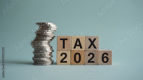 Wallpaper Mural Financial planning concept for the year 2026, featuring wooden blocks with TAX and a rising stack of silver coins Torontodigital.ca