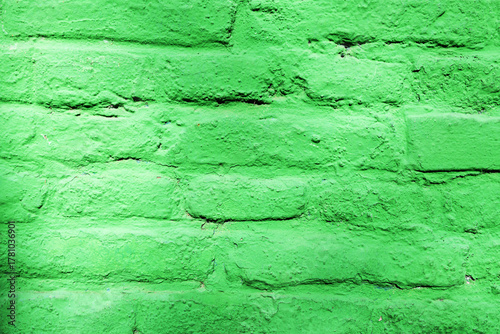 A brick wall painted green