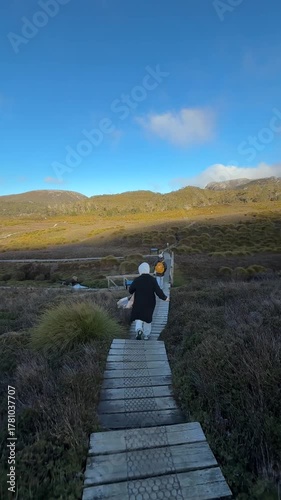 Iconic start of the Overland Track marked by a stone monument and boardwalk in the Tasmanian highlands.
