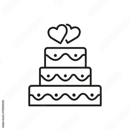 A threetiered cake with wavy lines and dots topped with two overlapping hearts