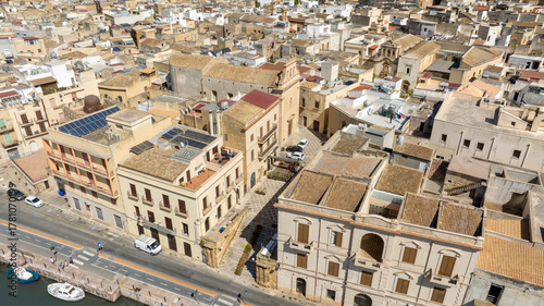 Fototapeta Naklejka Na Ścianę i Meble -  Aerial view of a small church among the alleys of the historic center of Mazara del Vallo, in the province of Trapani, Sicily, Italy. It's a beautiful sunny day.