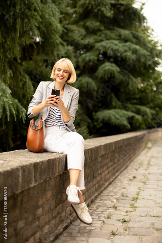 Woman relaxed on a stone wa...