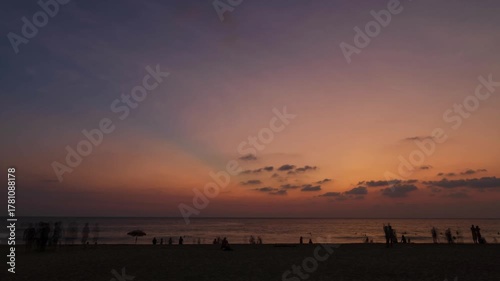 timelapse while people relaxing on the white sand beach during Summer Vacation sunset time at tropical beach in Karon,Phuket. People in vacations on a beautiful beach during summer sunset time
