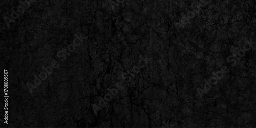 Black dark grunge stone texture with rough, natural wall surface background. uneven pattern resembling weathered black rock or charcoal. Panorama black canvas slate texture. blackboard background.