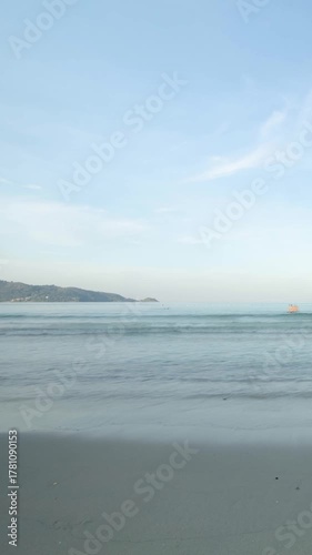 veritcal timelapse tropical white sand smooth beach with calm sea ocean and sunrise clear blue sky background.tropical white sand beach with blue sky and white cloud background in early morning. 