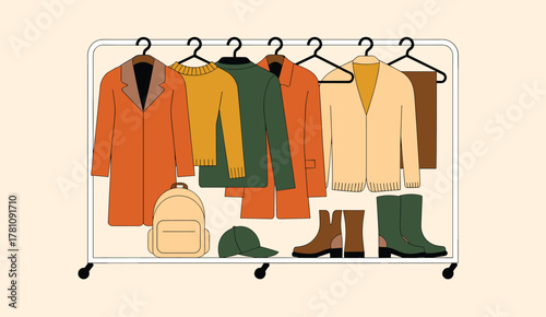 Autumn Clothing and Accessories Displayed on a Rolling Rack Keywords: autumn, fall, clothing, apparel, fashion, outerwear, coat, jacket, sweater