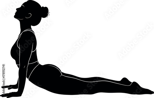 Silhouette of a woman in cobra pose during yoga