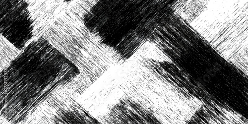 Abstract black and white grunge scratched diagonal intersecting pattern.