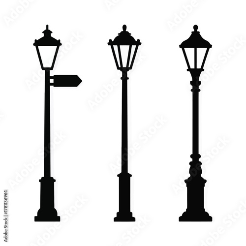 Three vintage street lamps in silhouette on white background