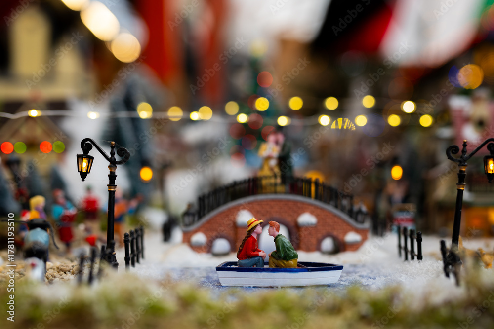 Obraz premium Romantic Miniature Boat Ride in Winter Village