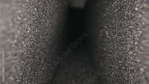 Abstract closeup of textured dark tunnel perspective in focus