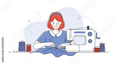 Happy young woman with red hair concentrating on her work while using a modern sewing machine to create new clothes.