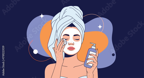 Young woman with a towel on her head applies a cosmetic face mask as part of her daily beauty and skincare routine at home.
