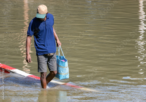 A man wades through a flooded street, Bangkok, Thailand