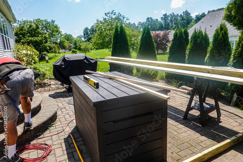 Fotografie Carpenter working on a paver outdoor patio and brick steps