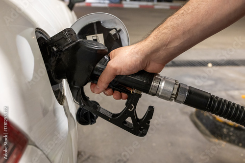 Man Refueling a Car at Gas Station