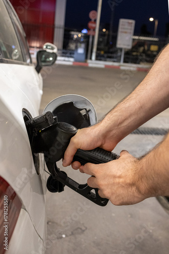 Man Refueling a Car at Gas Station
