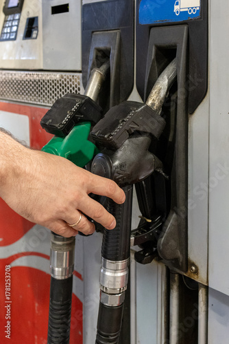 Man Refueling a Car at Gas Station