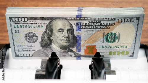100 Dollar Bills in Money Counting Machine