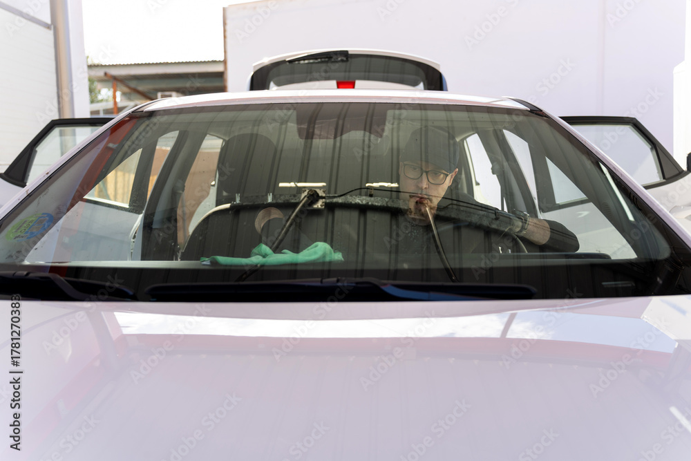 Fototapeta premium Professional car detailer cleaning car windshield
